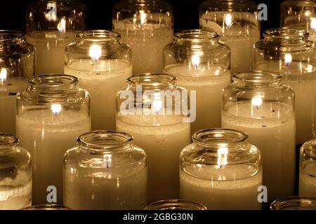Prayer candles burning inside a church in Northern California Stock Photo
