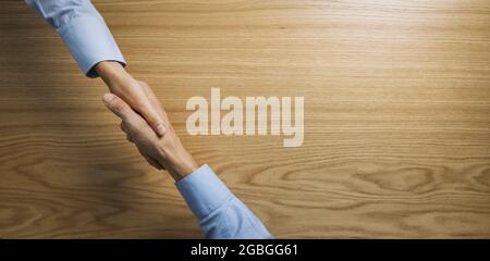 business people handshake over wooden table. businessmen agreement and partnership concept. banner copy space Stock Photo