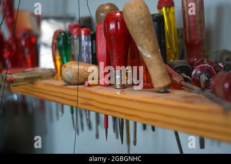 screwdriver, various, shelf, workshop, craft, craftsman, work, collection, tools, equipment, occupation, Various screwdrivers in a dusty wooden shelf Stock Photo