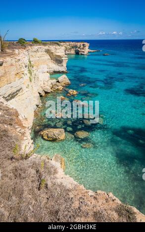 Torre Sant Andrea near Torre dell'Orso, Salento sea coast, Apulia, Italy. Beautiful rocky coast with cliffs and arch in Puglia. Blue turquoise saturated clear water. Bright Summer day. No people. Stock Photo