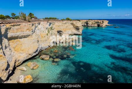 Torre Sant Andrea near Torre dell'Orso, Salento sea coast, Apulia, Italy. Beautiful rocky beach with cliffs in Puglia. Blue turquoise saturated clear water. Bright Summer day. No people. Stock Photo