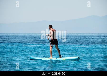 man practicing paddle in the ocean Stock Photo