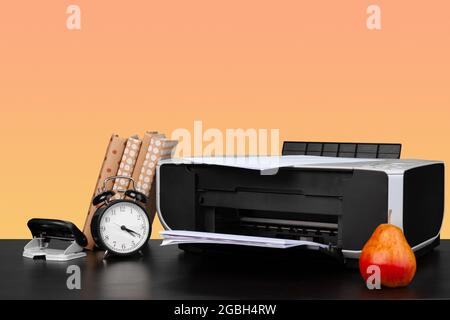 Compact home laser printer against orange background Stock Photo