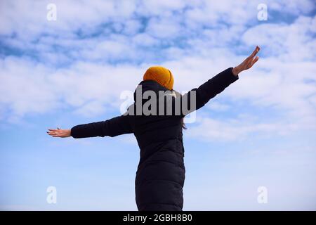 Freedom and feel good woman standing with open hands in airplane pose. Dreaming about flight Stock Photo
