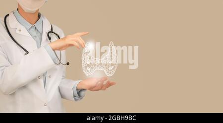 Female doctor holding virtual Thyroid Gland in hand. Handrawn human organ, copy space on right side, beige color. Healthcare hospital service Stock Photo