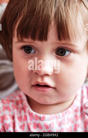 Portrait of a sad little girl with a scratched nose, close-up, selective focus. Child safety concept, injuries from falling down Stock Photo