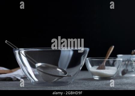 Empty transparent bowl and dishes on the kitchen table. Close-up Stock Photo
