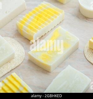 DIY soaps. Many various white homemade bar soaps. Handmade yellow colorful soap, spa bath products for body spa skin care. Hygiene toiletries Square Stock Photo