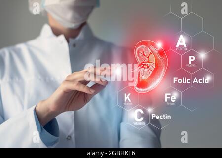 Essential nutrients for Spleen health including Pectin, Folic Acid, Vitamin P, Ferrum. Blurred portrait of doctor holding highlighted red volumetric d Stock Photo