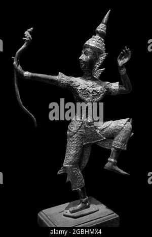 Prince Rama statue with a bow. Archer, Rama of Hinduism sculpture isolated on black background Stock Photo