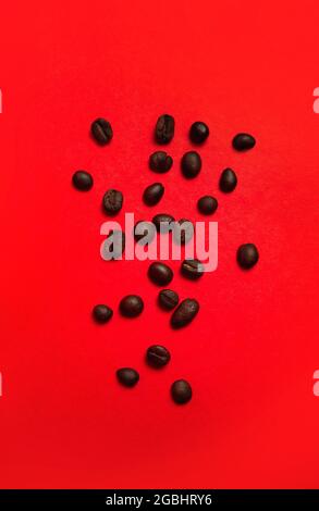 coffee beans close-up on a red background. Stock Photo