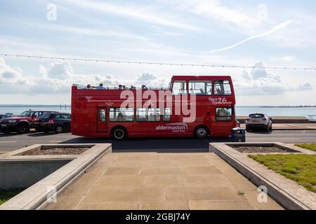 08-04-2021 Portsmouth, Hampshire, UK An open top tour bus traveling along southsea Seafront in Portsmouth in summer Stock Photo