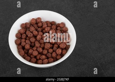 Balls of chocolate flakes on a black stone surface Stock Photo