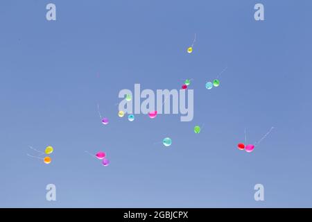 Multicolored balloons against the blue sky. Stock Photo