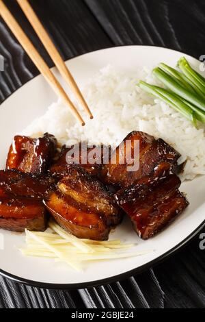 Rafute Okinawan Braised Pork Belly with rice closeup in the plate on the table. Vertical Stock Photo