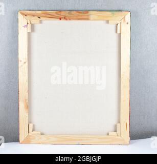 Wooden frame from the picture on the back against the background of the gray wall. Stock Photo