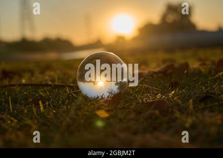 Beautiful sunset in the abstract misrepresentation of a glass ball in a ...