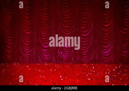Theatrical background. Red stage curtains and sequined floor. Stock Photo