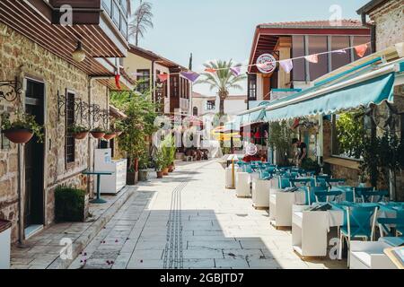 Antalya, Turkey - 2 August 2021: Streets of the old town of Kaleici. Street cafes and shops for tourists. Attractions, rest and travel in Antalya. High quality photo Stock Photo