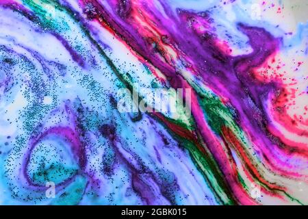 Multicolored colorful background of bright colors covered with gold sparkles. Stock Photo