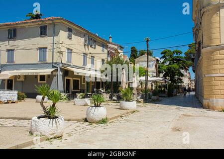Porec, Croatia- July 10th 2021. A pedestriaised square in the centre of the historic medieval coastal town of Porec in Istria, Croatia Stock Photo