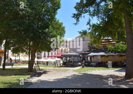 Porec, Croatia- July 10th 2021. A park square in the cenntre of the historic medieval coastal town of Porec in Istria, Croatia Stock Photo
