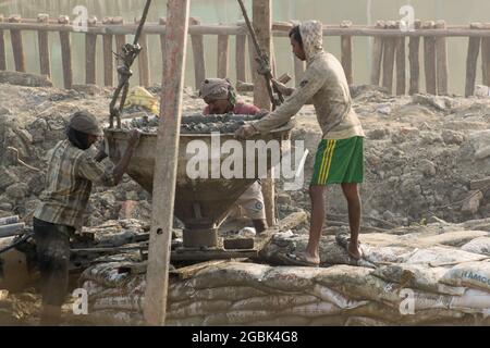 KOLKATA , INDIA - APRIL 21, 2017: Indian worker working at site. Piling work being done to support a superstructure. India is developing it's infrastr Stock Photo