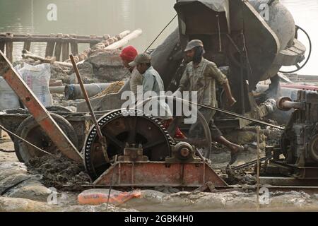 KOLKATA , INDIA - APRIL 21, 2017: Indian workers working at smoke covered project site. Black smokes coming out of diesel generator polluting environm Stock Photo