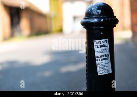 Woodbridge Suffolk UK July 21 2021: An anti vaccination sticker that has been stuck and littered around a town centre spreading disinformation about t Stock Photo