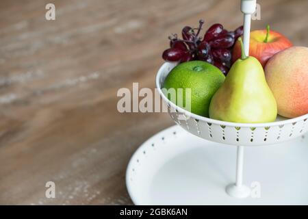 Fruit in white wire basket Stock Photo