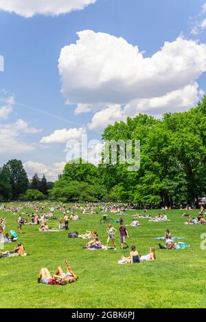 People relax on the Sheep Meadow of Central Park amidst Pandemic of COVID-19 NYC. Stock Photo