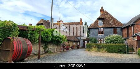 Barrels standing around half-timbered houses in Beuvron-en-Auge, France Stock Photo