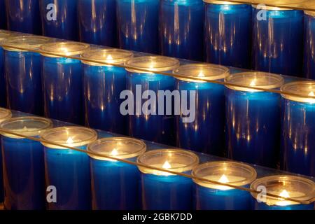 Prayer candles burning inside a church in Northern California Stock Photo