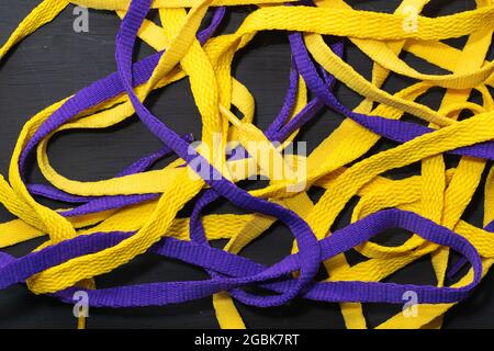 Yellow and purple shoelaces, Lakers flag, neatly placed on black wooden  background, leaving space for advertising text Stock Photo - Alamy