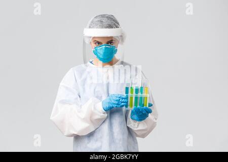 Covid-19, preventing virus, health, healthcare workers and quarantine concept. Young tech lab doctor working with test-tubes, coronavirus samples or Stock Photo