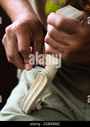 Luthier working on violin head and curl Stock Photo