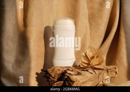 natural Deodorant or antiperspirant on wood podium with flower and sunlights Stock Photo