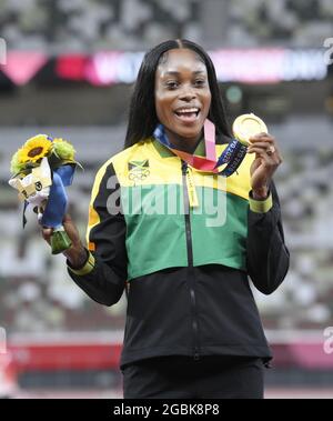 Jamaica's Elaine Thompson-Herah poses with her gold medal after winning ...