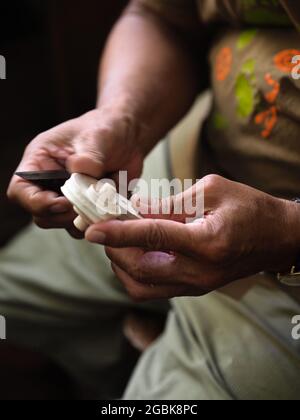 Luthier working on violin head and curl Stock Photo