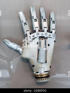 Detail of a human hand prosthesis with articulating joints for use as a replacement limb following amputation in a palm down view Stock Photo
