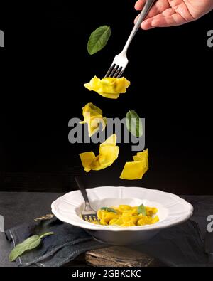 Creative concept with falling food on black backdrop Stock Photo