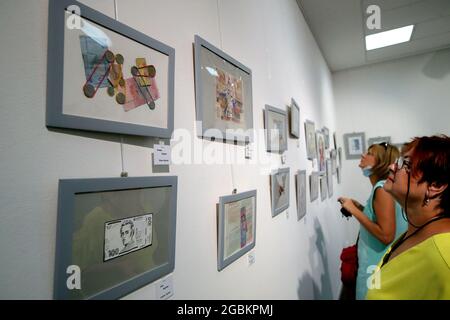 KYIV, UKRAINE - AUGUST 4, 2021 - Visitors look at artworks at the opening of the Hryvnia ART exhibition dedicated to the upcoming 30th Independence Da Stock Photo
