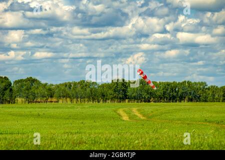 airfield weather vane - a windsock sagged indicating a light wind on the airfield Stock Photo