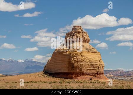 Huge round domed  rock in a field in Colorado USA known as Church rock or the Teapot dome with blue mountains in the background. Stock Photo