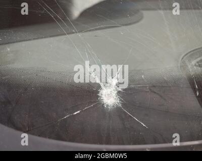 car front window broken with a stone Stock Photo