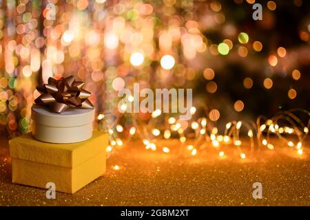 two gift boxes on a golden bokeh background.  Stock Photo