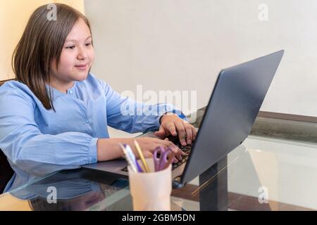 Blonde girl studying on a laptop Stock Photo