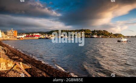 Oban, Scotland, UK - June 3, 2011: Sun shines on fishing boats and a wreck in the harbour at Oban in the West Highlands of Scotland. Stock Photo