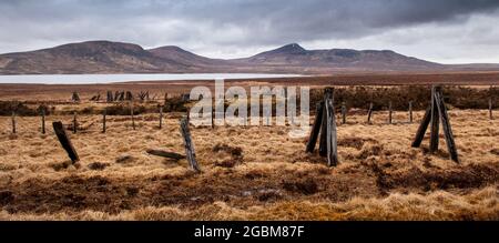 Mountains rise from the peat bog moorland of Sutherland in the Far North of the Highlands of Scotland. Stock Photo