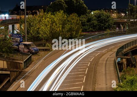 Traffic leaves light trails at night on the mid-20th century Cumberland Basin road system in Hotwells, Bristol, an area scheduled for regeneration. Stock Photo